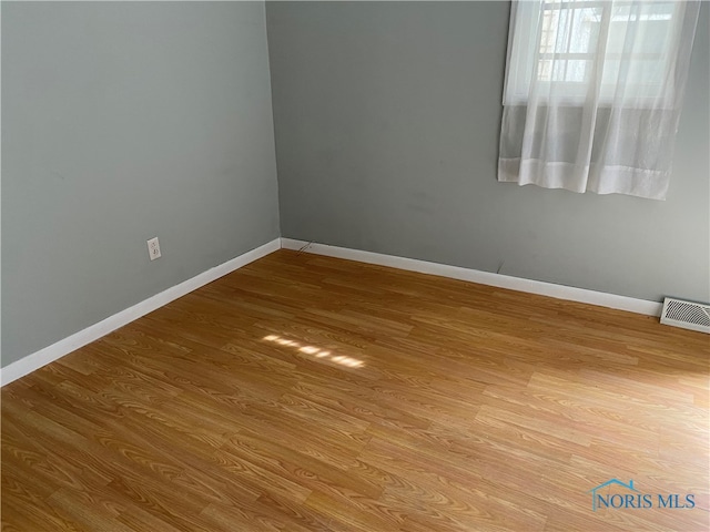 spare room featuring light wood-type flooring