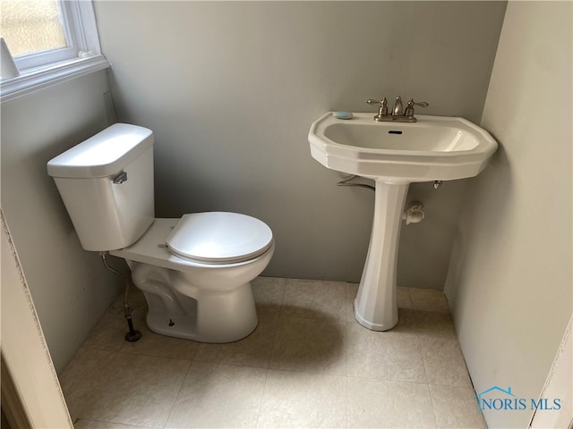 bathroom with toilet and tile patterned floors