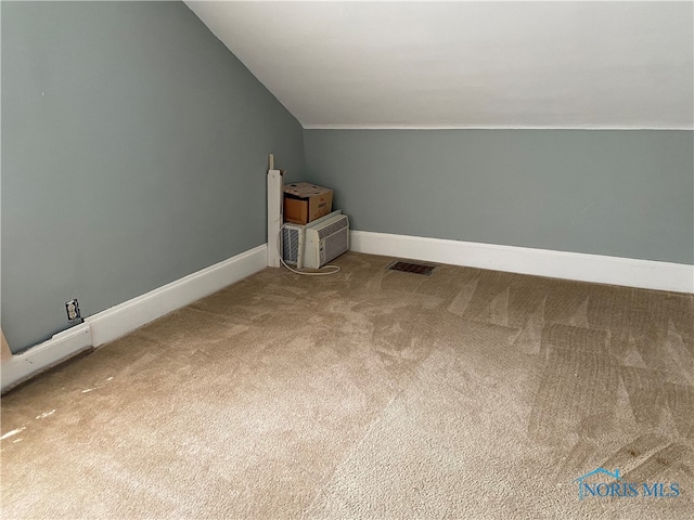 bonus room with lofted ceiling and carpet