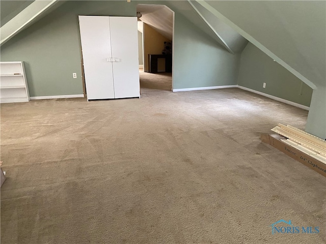 additional living space with light carpet and lofted ceiling