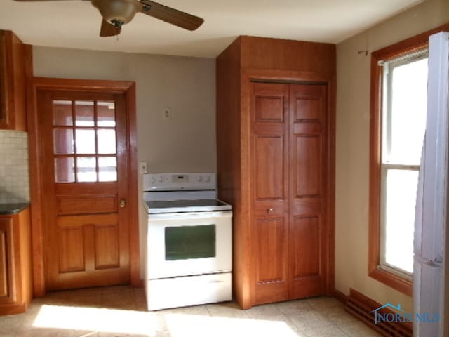 kitchen with plenty of natural light, ceiling fan, electric range, and tasteful backsplash