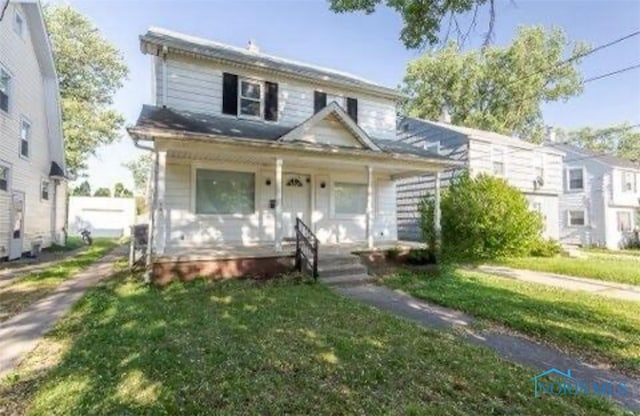 view of front of house with a front yard and a porch