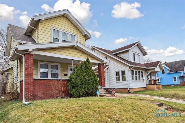 view of front of home with a front lawn and a porch