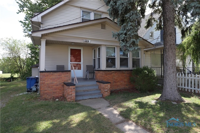 bungalow-style home with a porch and a front yard