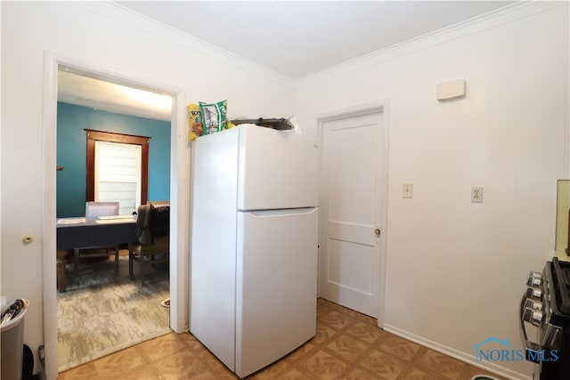 kitchen with ornamental molding, white refrigerator, light wood-type flooring, and stainless steel range oven