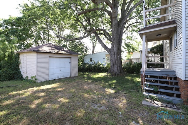 view of yard with a garage and an outdoor structure