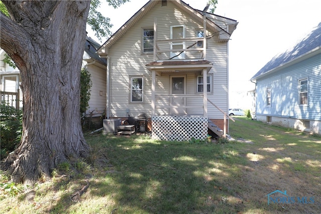 back of property featuring a lawn and a balcony