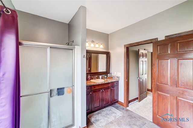 bathroom with an enclosed shower and vanity