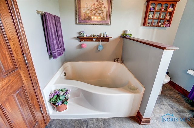 bathroom featuring toilet and a bathing tub