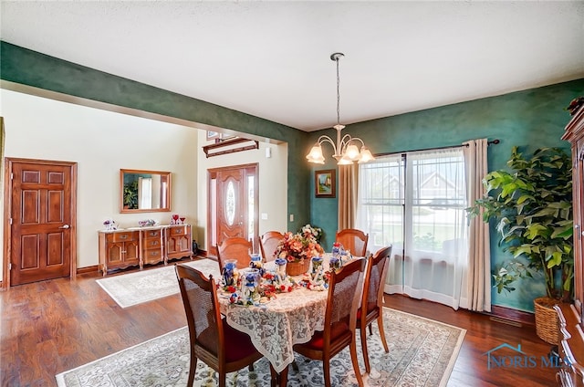 dining area featuring a healthy amount of sunlight, a chandelier, and dark hardwood / wood-style floors