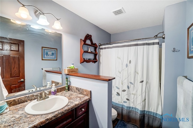 full bathroom with shower / bath combo with shower curtain, toilet, and vanity