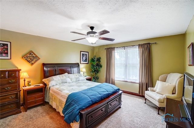 carpeted bedroom with a textured ceiling and ceiling fan