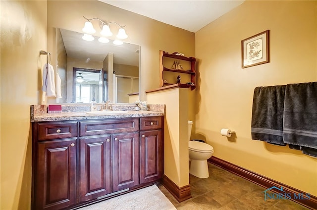 bathroom with vanity, toilet, and a shower with shower door