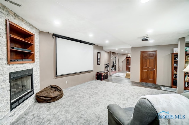 home theater room featuring a fireplace and hardwood / wood-style flooring