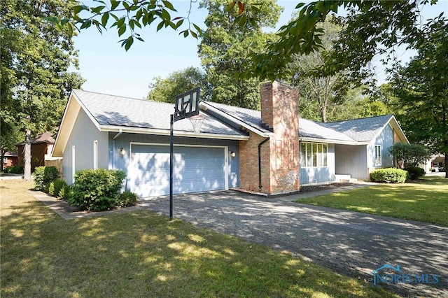 ranch-style house with a garage and a front lawn