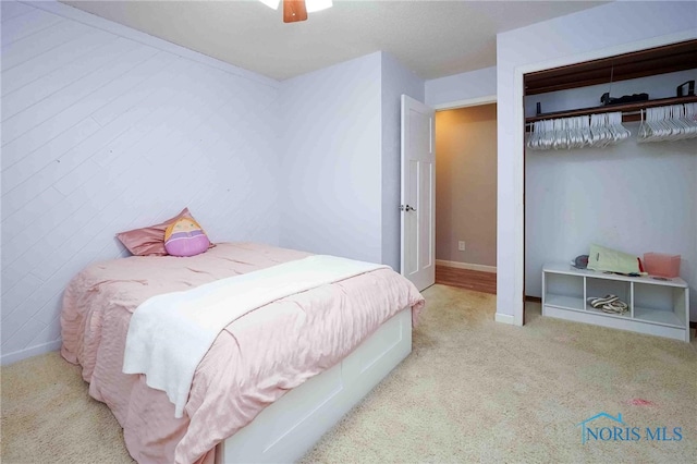 bedroom featuring ceiling fan and light carpet