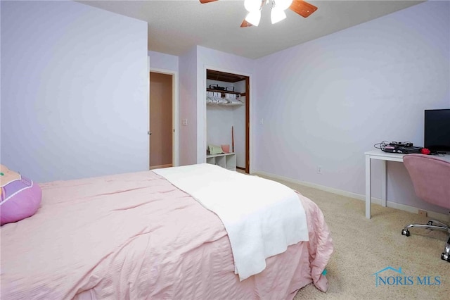 carpeted bedroom featuring ceiling fan and a closet