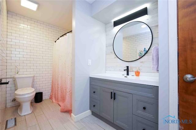 bathroom featuring vanity, walk in shower, tile walls, toilet, and hardwood / wood-style flooring