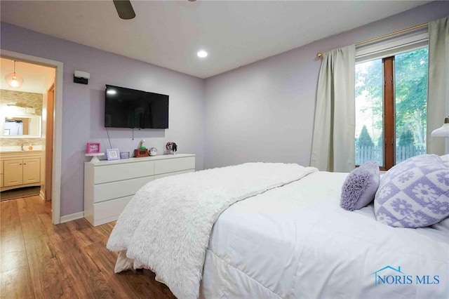 bedroom with ceiling fan, sink, ensuite bath, and light hardwood / wood-style flooring