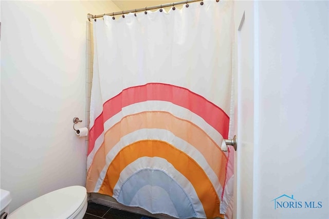 bathroom with tile patterned flooring and toilet