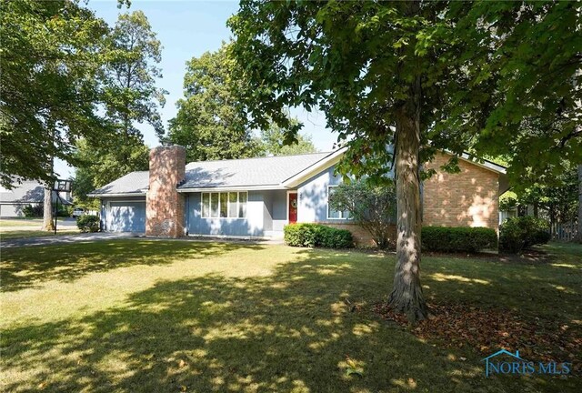 ranch-style home with a garage and a front yard