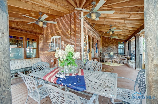 sunroom featuring lofted ceiling with beams and ceiling fan