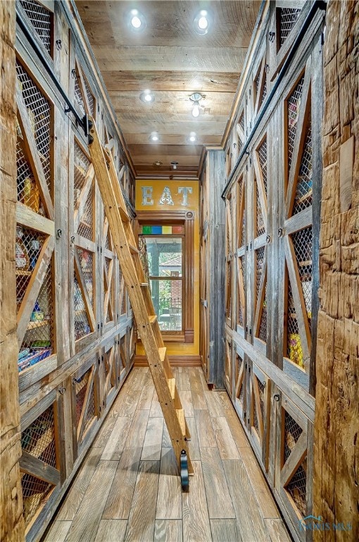 interior space with wooden ceiling, crown molding, and wood-type flooring