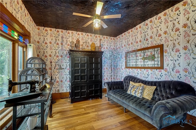 living room featuring light hardwood / wood-style flooring and ceiling fan