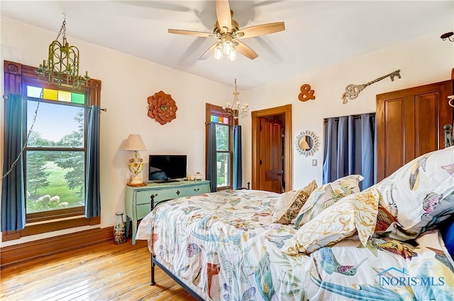 bedroom with ceiling fan and light hardwood / wood-style floors