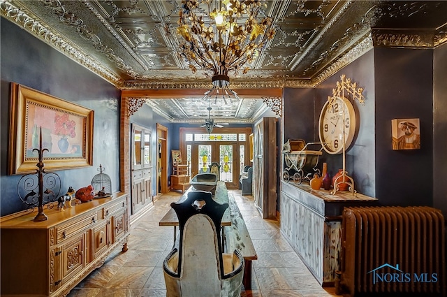 interior space featuring ornamental molding, radiator heating unit, and french doors