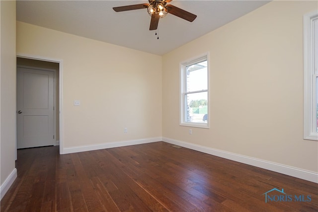 unfurnished room with ceiling fan and dark hardwood / wood-style floors