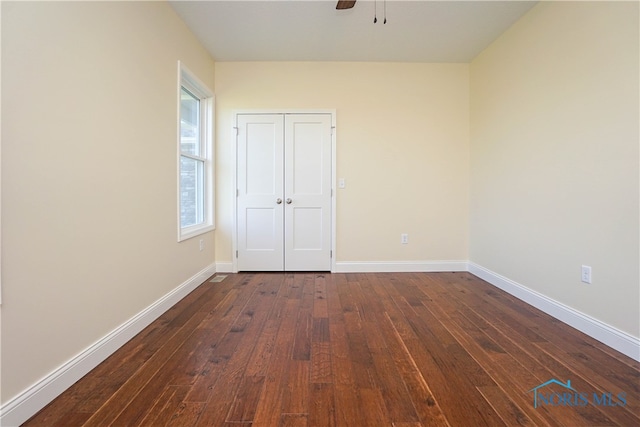 unfurnished room featuring ceiling fan and dark hardwood / wood-style floors