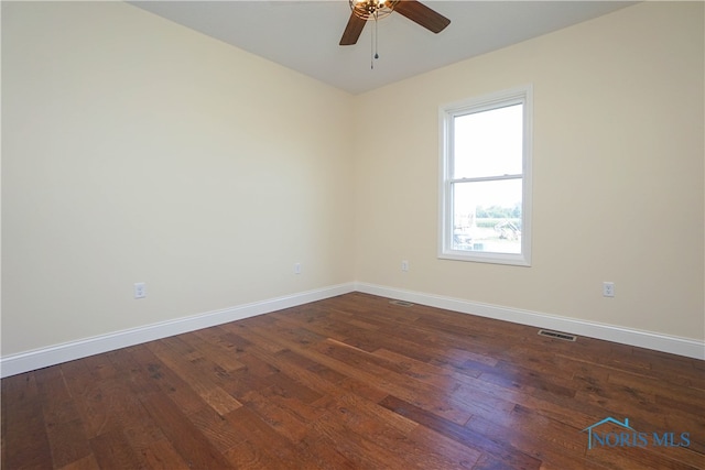 empty room featuring ceiling fan and dark hardwood / wood-style flooring