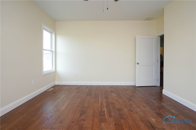 empty room with ceiling fan and dark hardwood / wood-style floors