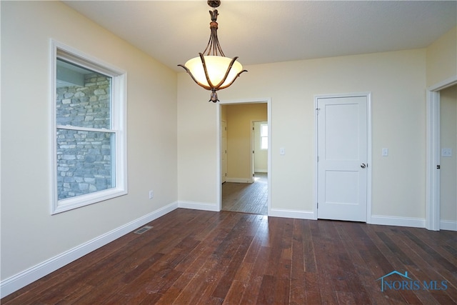 unfurnished room featuring dark wood-type flooring