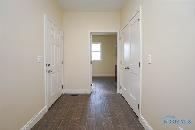 corridor featuring dark wood-type flooring