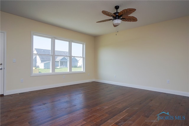 spare room featuring ceiling fan and dark hardwood / wood-style floors