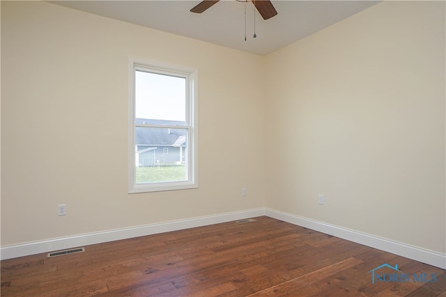 unfurnished room featuring ceiling fan and dark hardwood / wood-style flooring