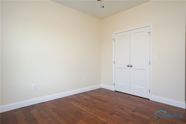 unfurnished bedroom featuring dark hardwood / wood-style flooring