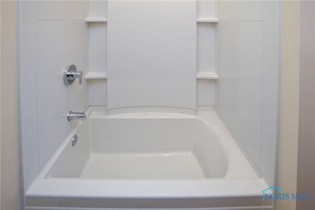 bathroom with a tub to relax in