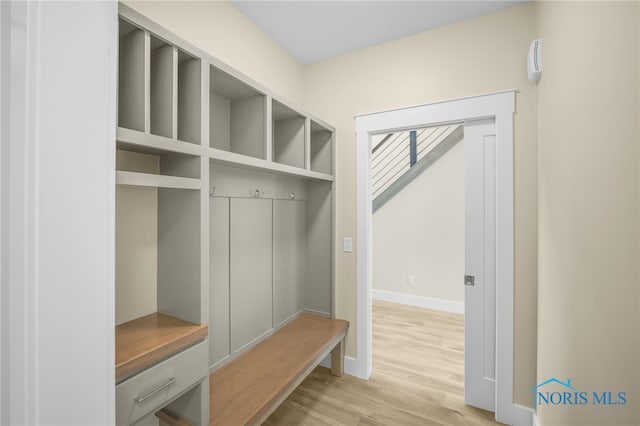 mudroom with light wood-style flooring and baseboards