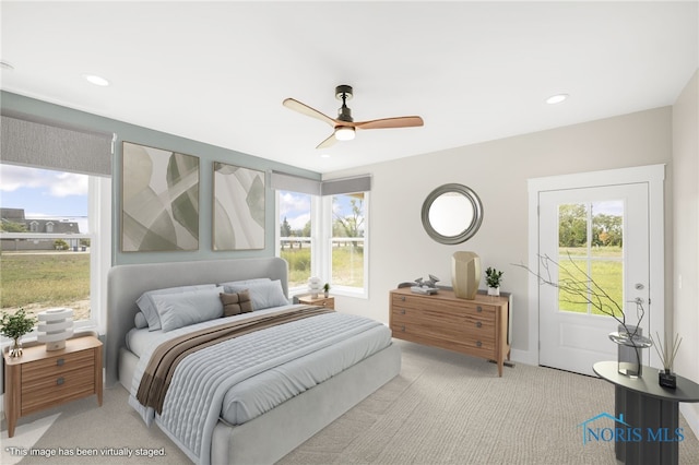 bedroom with ceiling fan and light colored carpet