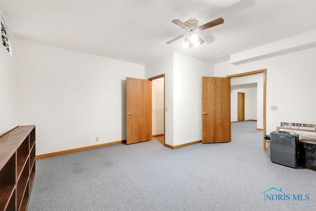 unfurnished bedroom featuring ceiling fan and light carpet