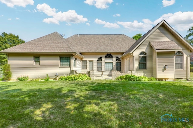 rear view of house with a lawn