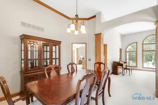 carpeted dining space featuring a notable chandelier