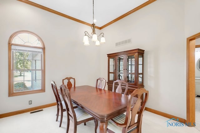 dining space with light carpet, crown molding, a notable chandelier, and a towering ceiling