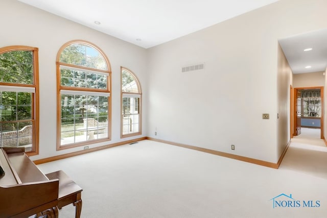 carpeted spare room with a healthy amount of sunlight