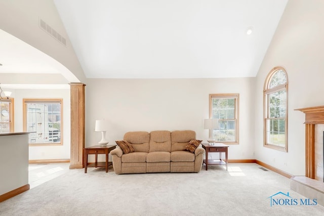 living room with high vaulted ceiling and light carpet