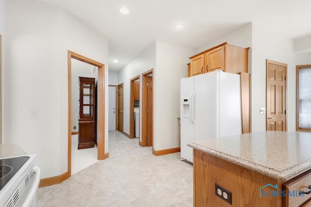 kitchen with white fridge with ice dispenser