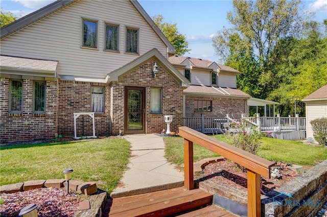 view of front of home featuring a deck, a front lawn, and a patio area